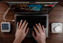 Overhead view of Logitech MX Creative Console flanking a MacBook Pro.