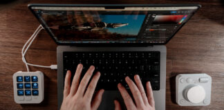 Overhead view of Logitech MX Creative Console flanking a MacBook Pro.