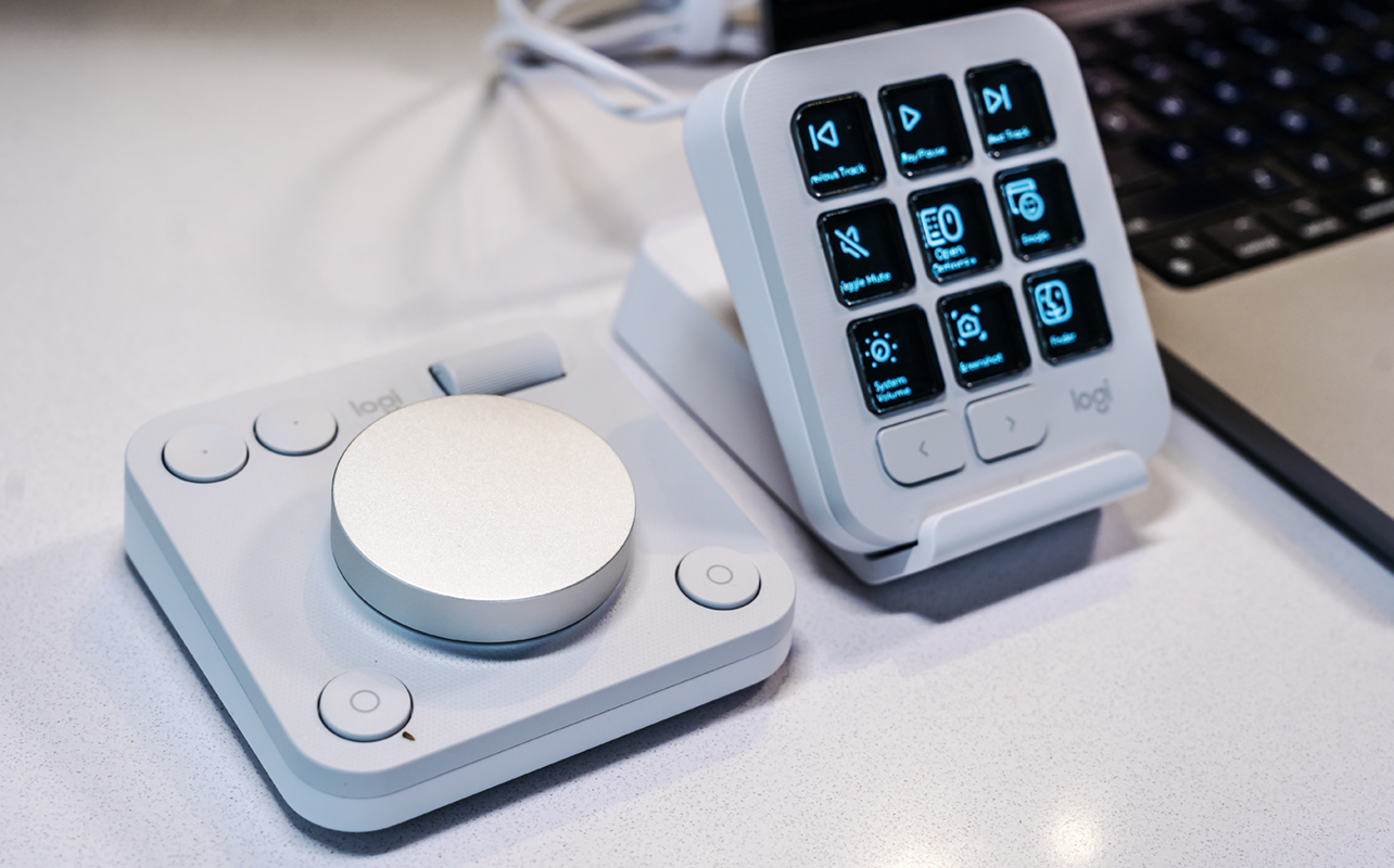 Logitech MX Creative Console Dialpad and Keypad next to each other with Keypad propped up on stand.