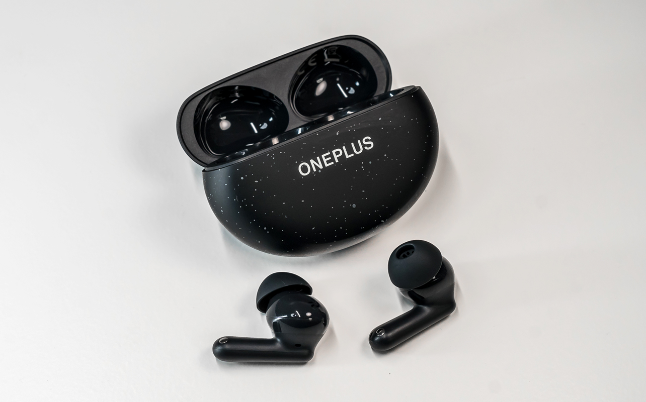 OnePlu sNord Buds 3 Pro earbuds loose in front of open case.