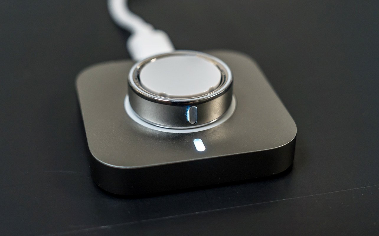 Oura Ring 4 charging on its charging dock.