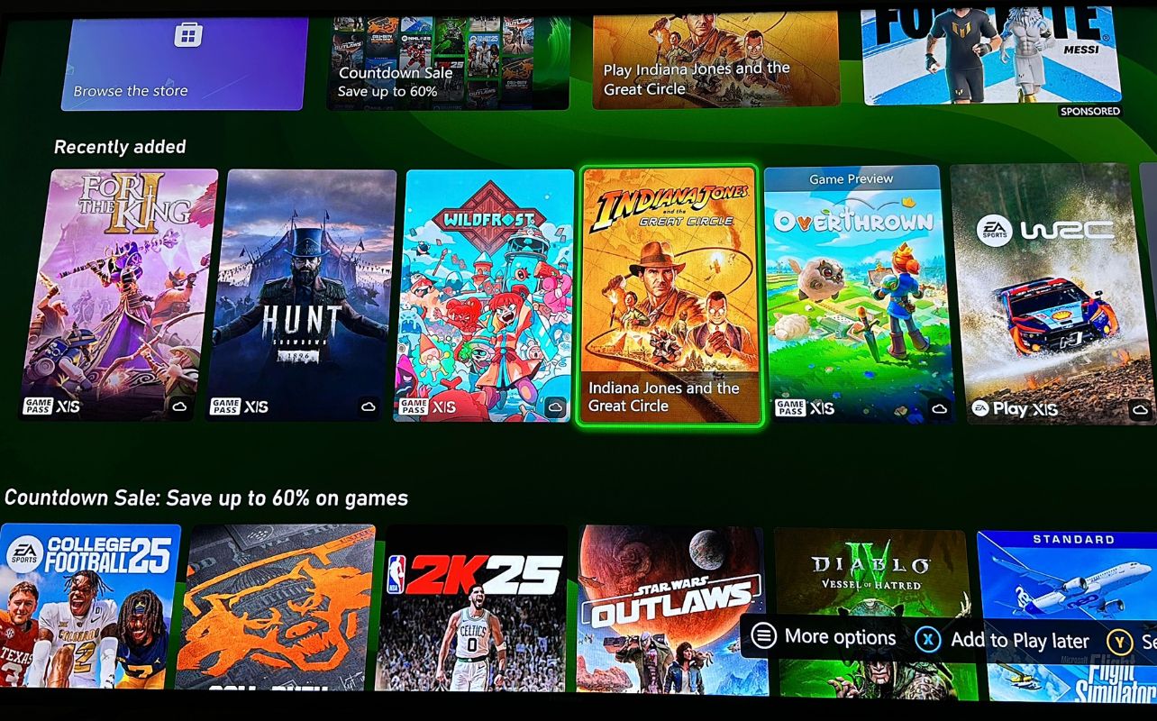 A TV screen displaying the latest offerings for Xbox Game Pass with Indiana Jones and the Great Circle.