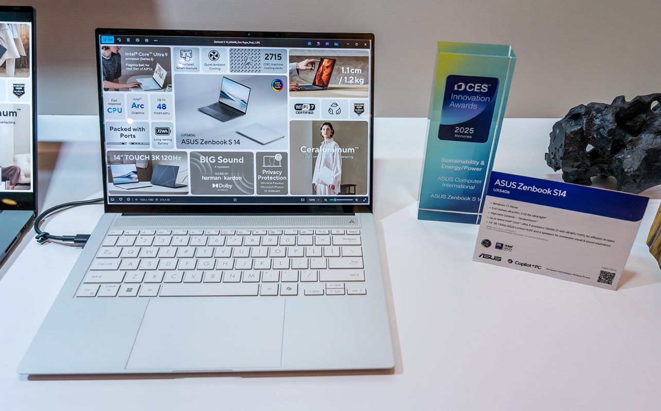 ASUS Zenbook S14 sitting on table with screen on.