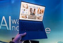 ASUS Vivobook S14 in hand showing lightweight body.