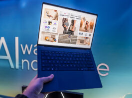 ASUS Vivobook S14 in hand showing lightweight body.