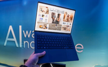 ASUS Vivobook S14 in hand showing lightweight body.