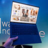 ASUS Vivobook S14 in hand showing lightweight body.