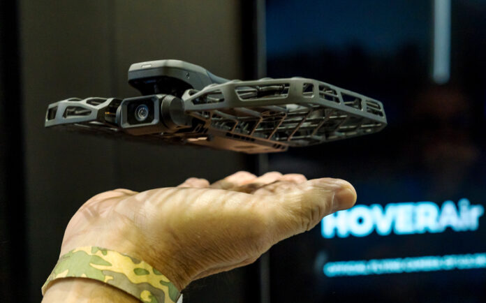 HoverAir X1 taking off from a man's hand at CES 2025.