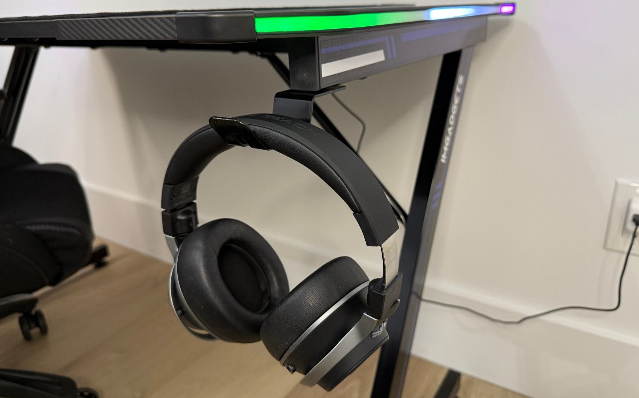 The IMGadgets Z-Shaped Gaming Desk with a headset hanging off of the desk's hook.