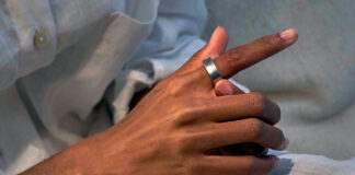 Man putting on Samsung Galaxy Ring on right index finger.