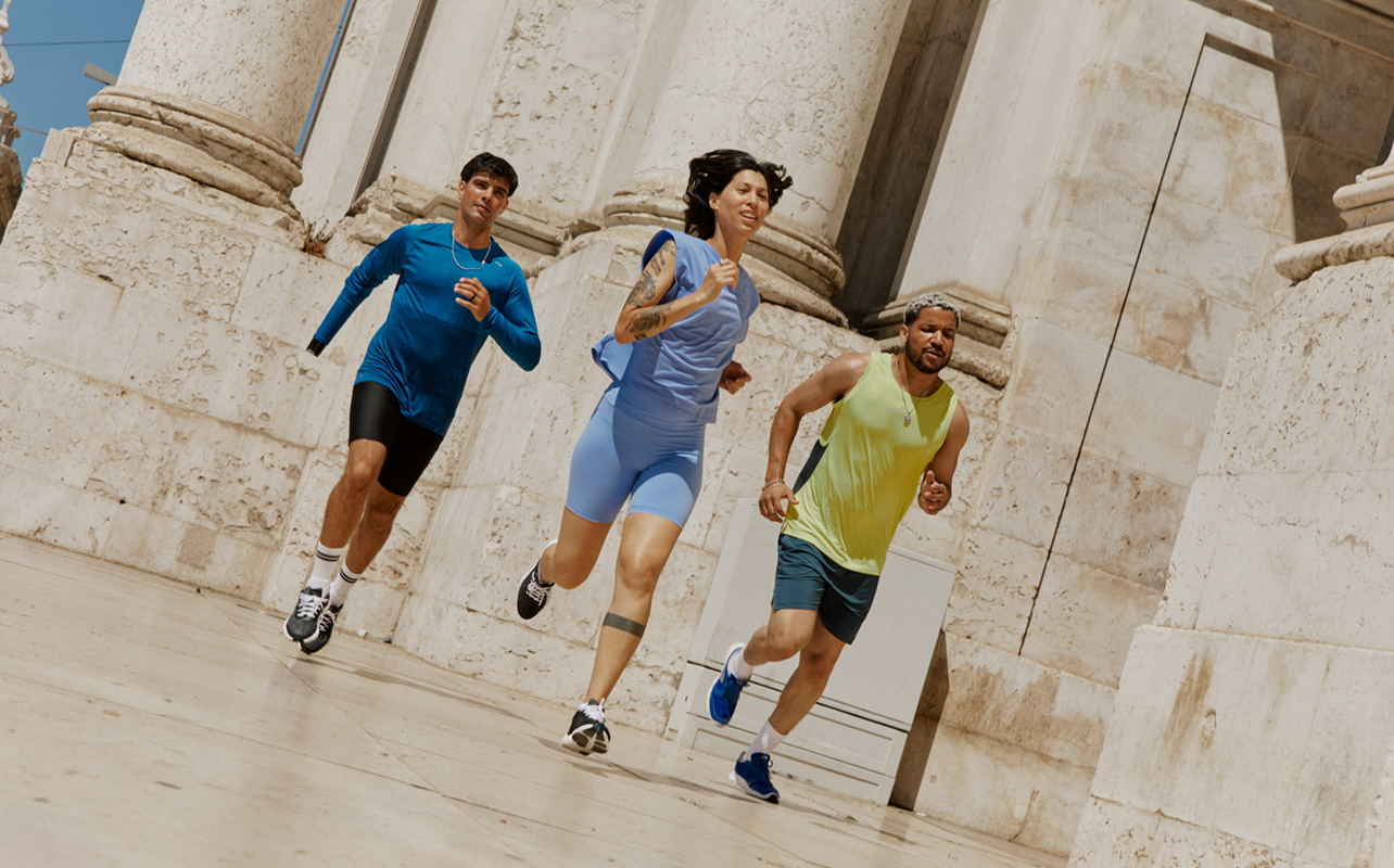 A woman and two men outside running wearing smart rings.