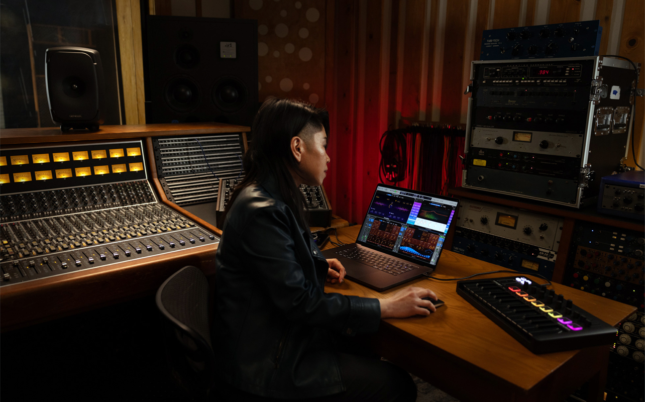 Woman running Logic Audio on a MacBook Pro in a studio.