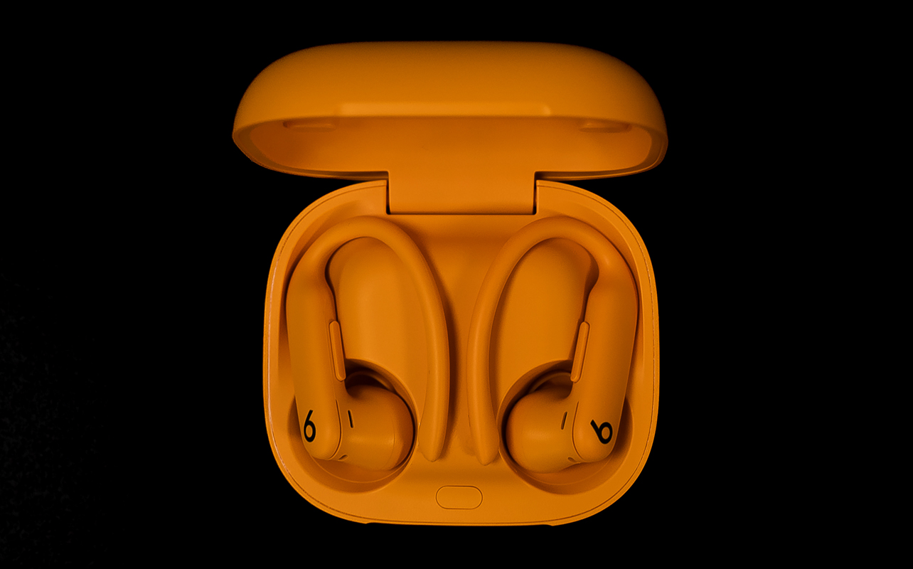 Beats by Dr. Dre Powerbeats Pro 2 in orange open case with earbuds inside.