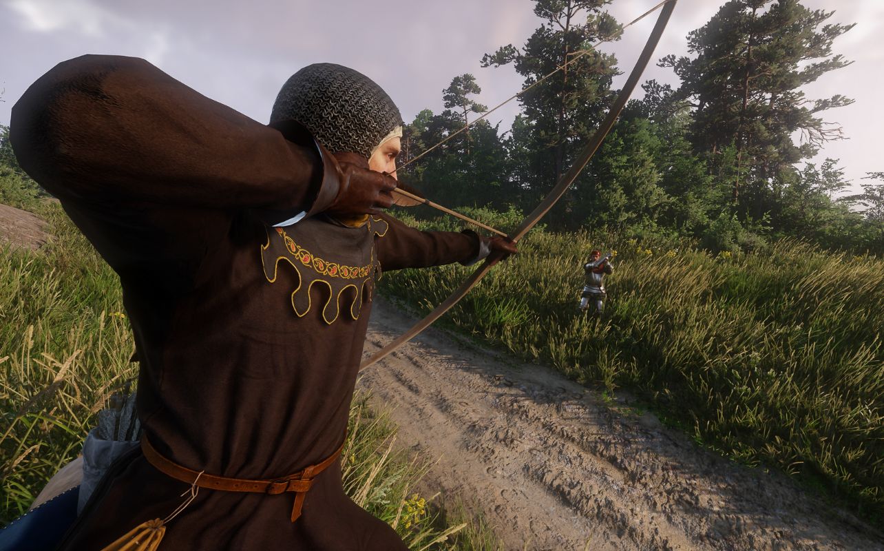 A screenshot of the video game Kingdom Come Deliverance II depicts a character with a bow and arrow pointed at a person hidden in tall grass.