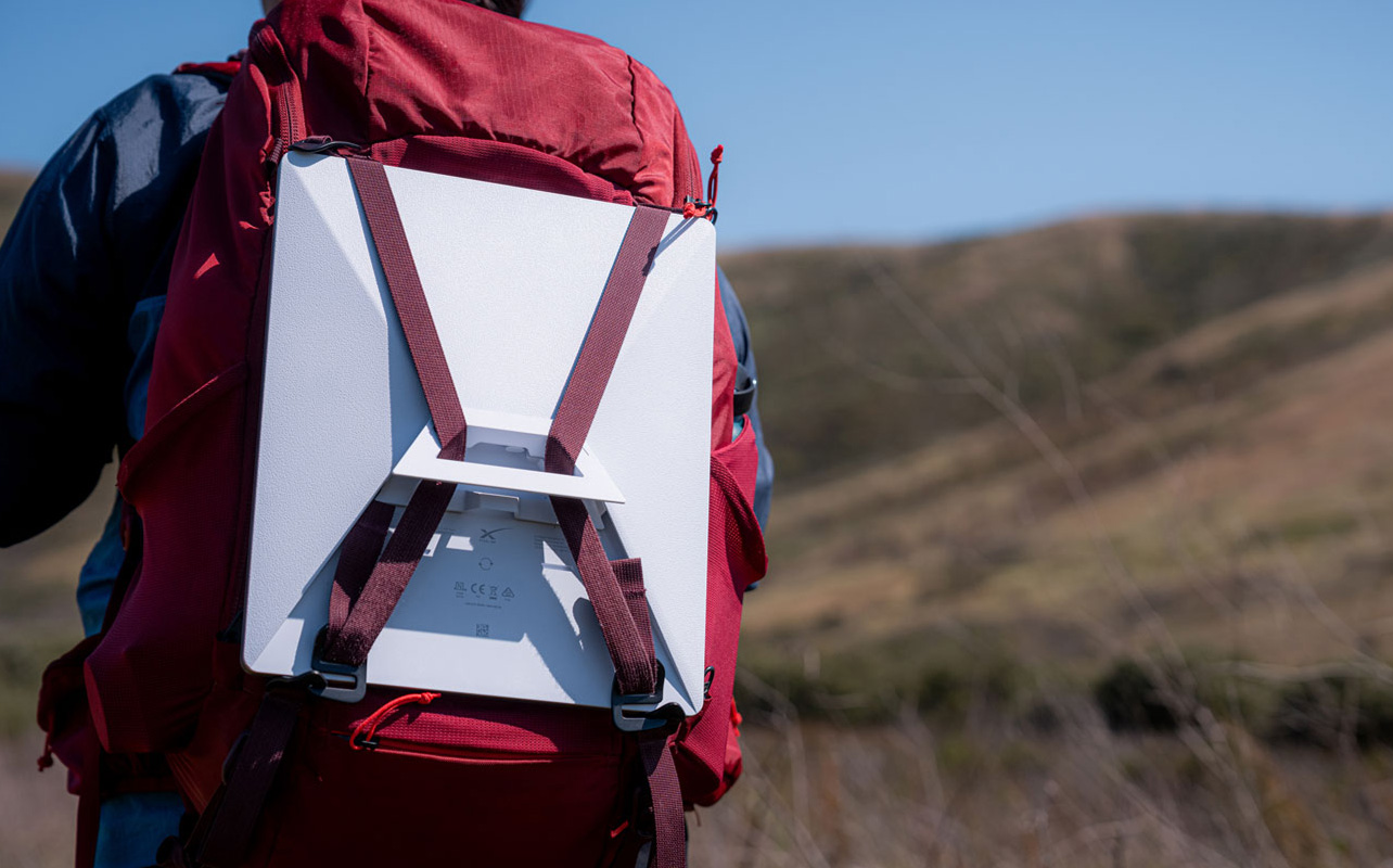 Person carrying Starlink Mini on backpack.