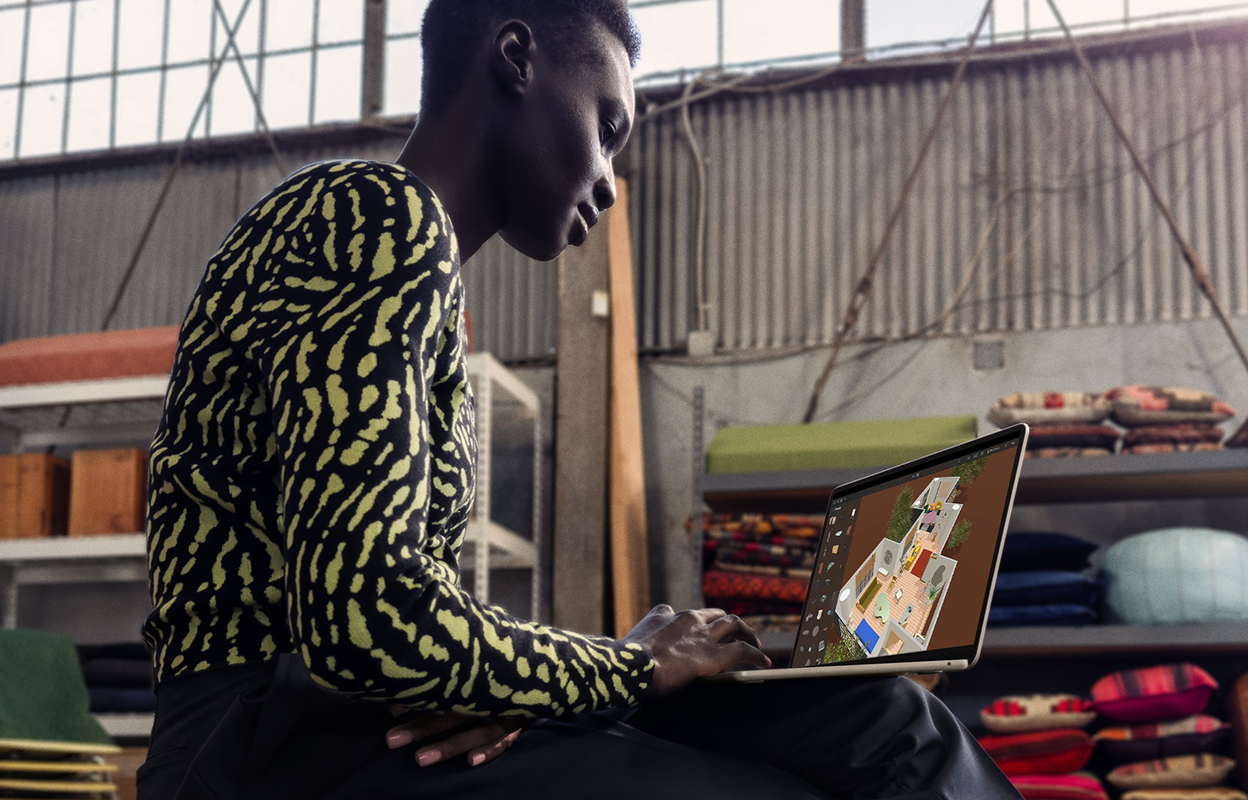 Woman doing creative work on a laptop.