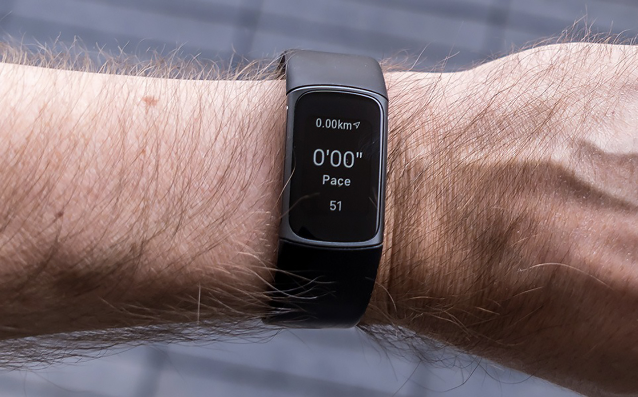 A male arm wearing the Fitbit Charge 5