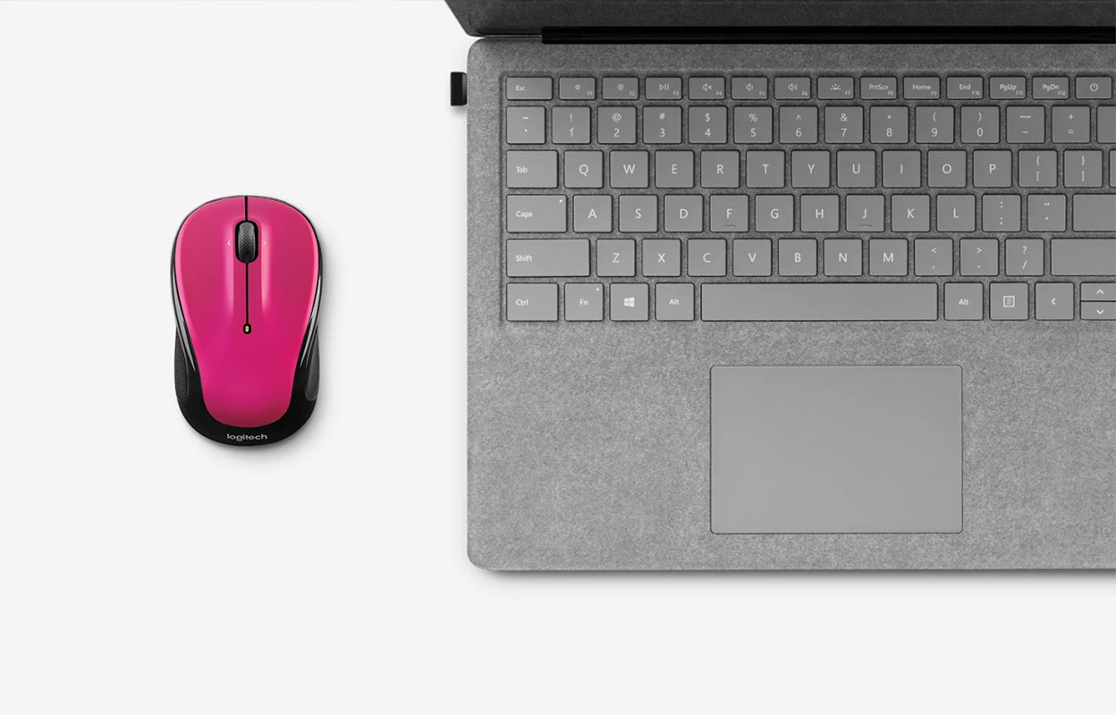 Logitech wireless mouse with USB dongle paired with a tablet.