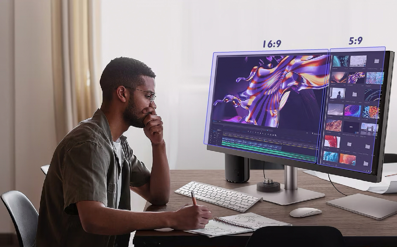 Man editing video content on computer monitor.