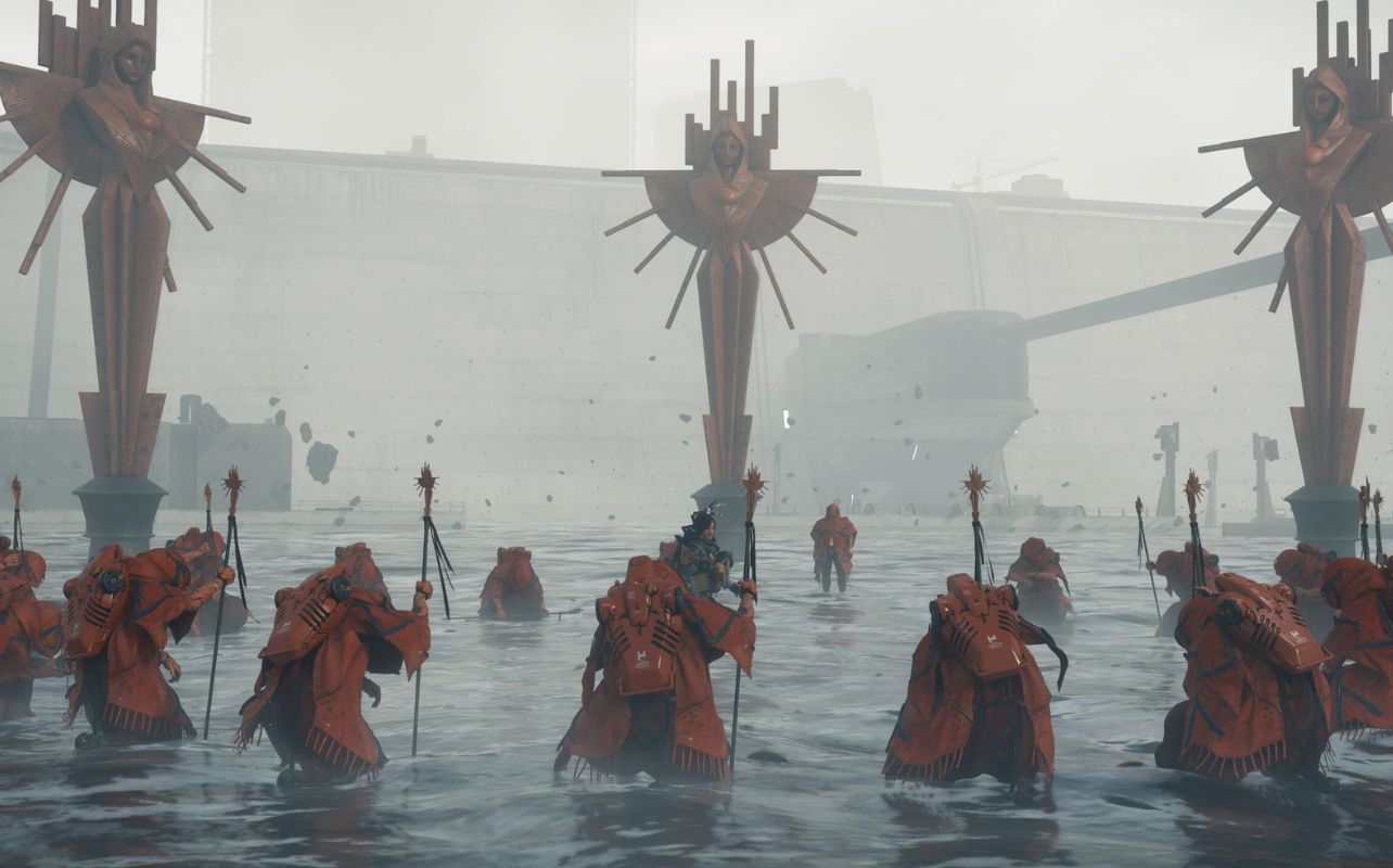 Death Stranding 2: On the Beach screenshot showing off characters surrounding main protagonist.