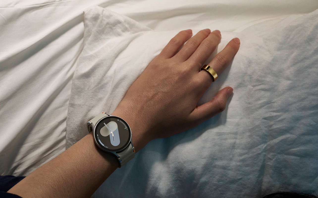 Person's hand wearing a Samsung Galaxy Watch and Galaxy Ring.