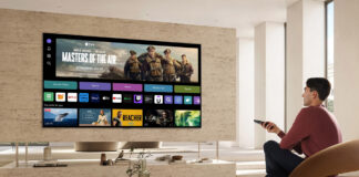 Man watching TV with smart TV interface onscreen.