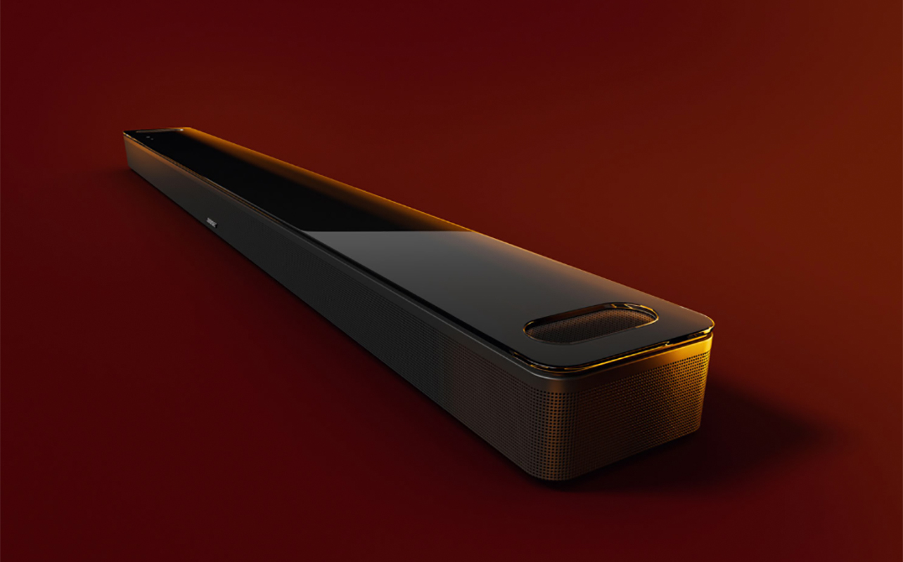 Bose Smart Ultra sound bar on an angle with a maroon background.