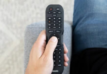 A Philips universal remote in hand.