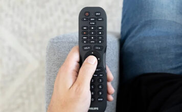 A Philips universal remote in hand.