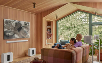 The most common home theatre organization mistakes people make and how to fix them Two people watching TV with a Sonos Arc sound bar mounted underneath.