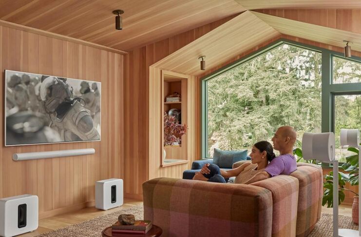 The most common home theatre organization mistakes people make and how to fix them Two people watching TV with a Sonos Arc sound bar mounted underneath.