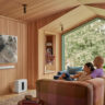 Two people watching TV with a Sonos Arc sound bar mounted underneath.