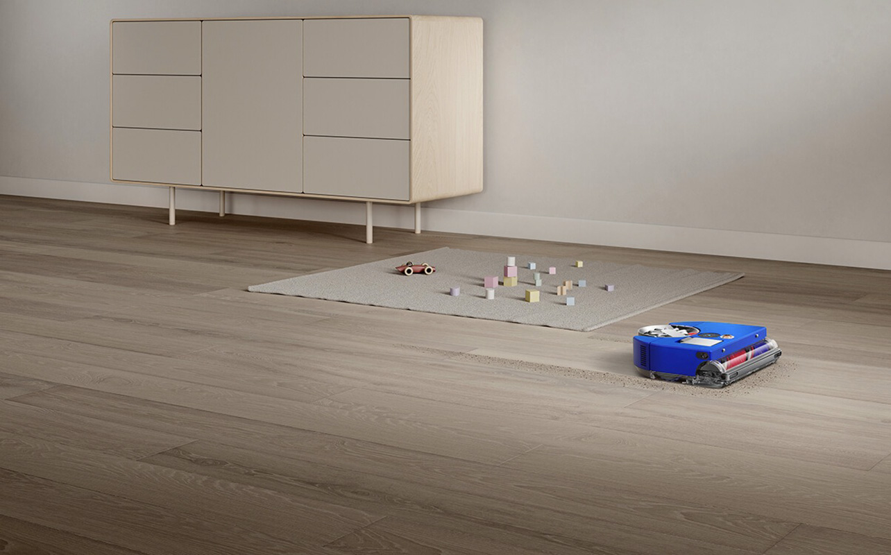 Dyson Vis Nav robot vacuum scooting along the floor.