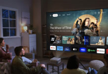 People sitting in a living room looking at a smart TV menu from an Epson Epiqvision Mini EF21 projector