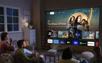 People sitting in a living room looking at a smart TV menu from an Epson Epiqvision Mini EF21 projector