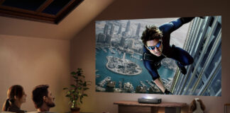 A man and woman watching a large screen from a Hisense PL2 laser projector