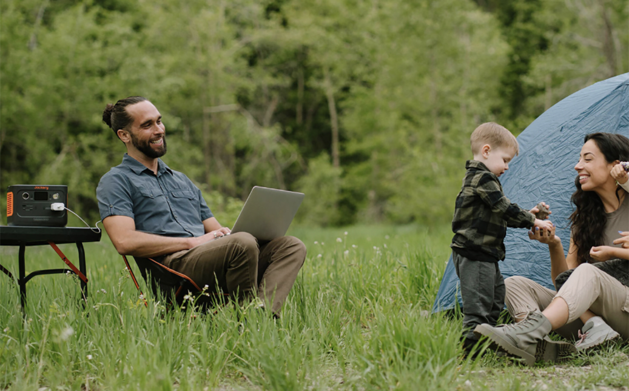 A family sitting outside with the Jackery Explorer 280 portable power station