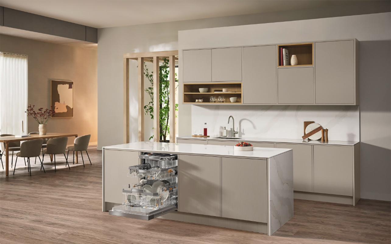 A Miele dishwasher open in the kitchen