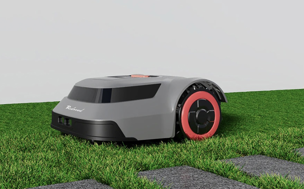 A Redroad robot lawnmower scooting across the edges of grass.