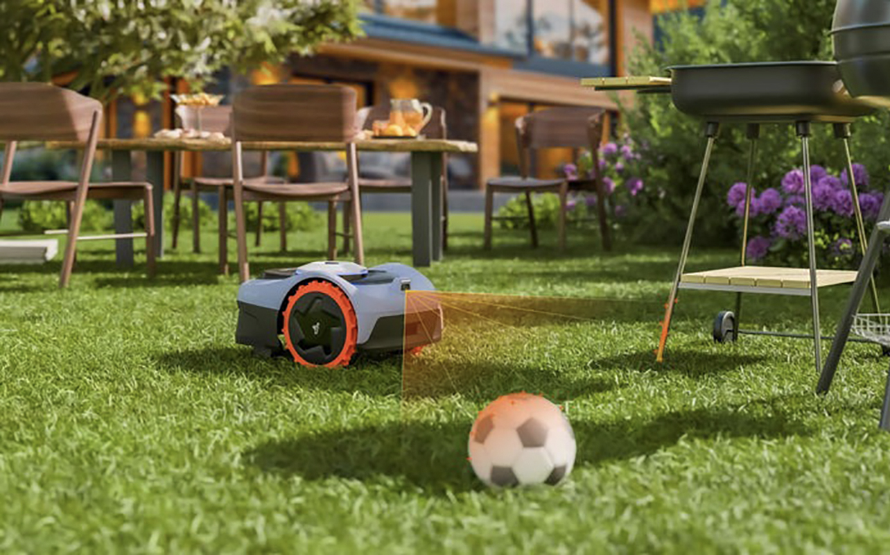 A Segway Navimow robot lawnmower showing a sensor detecting a nearby soccer ball to avoid it.