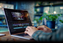 Man editing video on AI laptop.