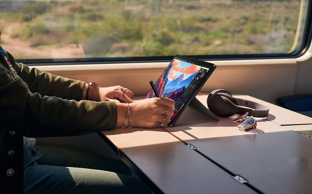 Man working on art on an AI laptop.