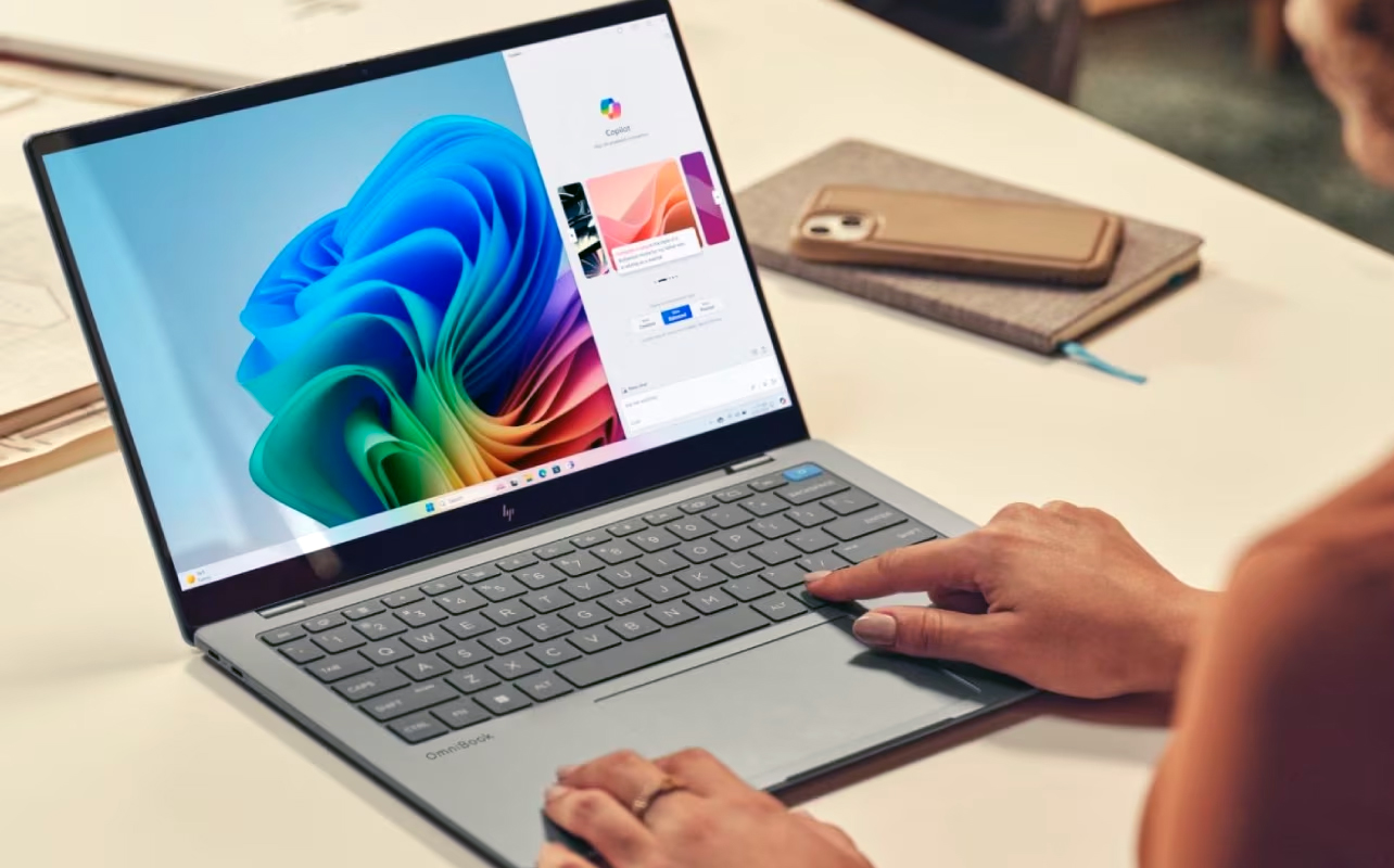 Woman using Copilot+ features on AI laptop.