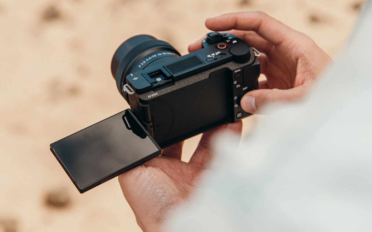 Sony ZV-E10 II in hand.