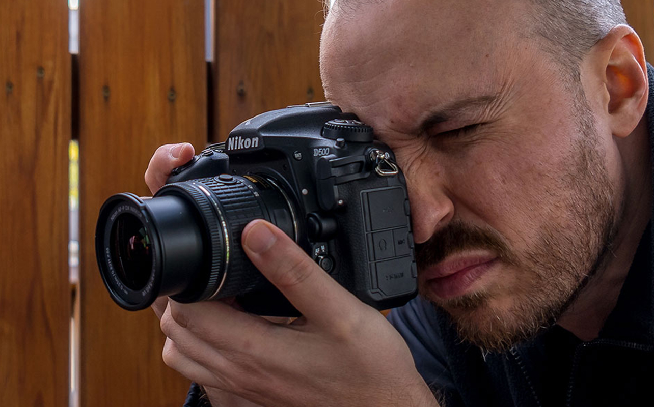 Photographer shoots with a Nikon DSLR camera