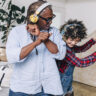 Father and daughter dancing with headphones on