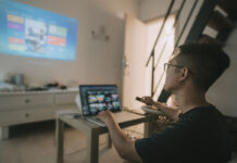 A person working from a projector onto the wall.
