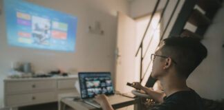 A person working from a projector onto the wall.