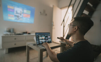 A person working from a projector onto the wall.