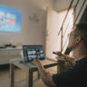 A person working from a projector onto the wall.